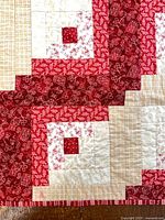 front of quilt showing red, cream patchwork blocks