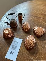 Entire lot showing four jelly molds, miniature kettle and slim pitcher