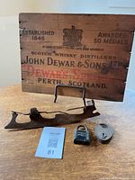 Front view of crate panel, skate blade and two padlocks