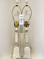 Full view of both matching ceramic lamps with harps and finials