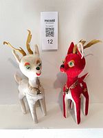 Both velvet reindeer standing side by side