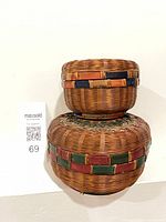 Two stacked lidded wicker baskets front view