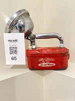 Side view showing red body, handle, model marking and MaxSold card