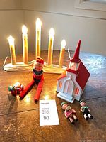 All items: seven-light candelabra, plastic church, two elves, two German figures