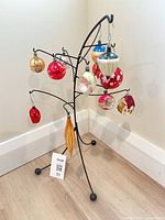 Full view of 12 ornaments hanging on stand