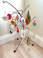 Full view of all twelve vintage glass ornaments displayed on stand