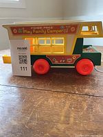 Left side view showing decals, red wheels, pull cord