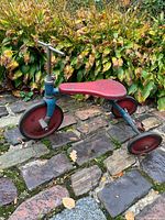 Left side view of complete tricycle showing wheels, seat, frame