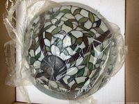 Stained glass shade sealed in plastic within box