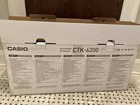 Rear of Casio CTK-6200 box with multilingual specs