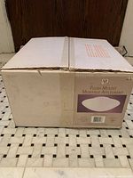 Front view of sealed box showing product image and logo