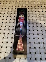 Front of unopened box showing candle design