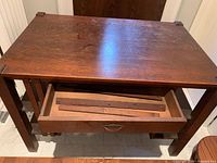 top view of oak Mission style desk showing grain and open drawer with loose slats