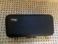 Closed black Armstrong hard shell saxophone case