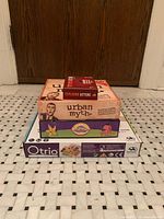 Stack of four game boxes showing all titles