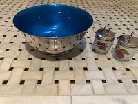 Top view of silver bowl showing turquoise interior and both egg coddlers