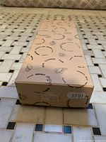 Closed Eaton’s printed cardboard box with price tag