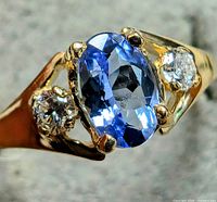 Angled view of ring showing tanzanite and one diamond