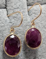 Front view of both ruby dangle earrings showing gemstones and settings