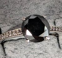 Top view of ring showing black diamond and accent diamonds