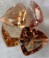 Trillion-cut gemstone showing color shift in different orientations