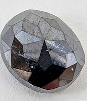 Close-up of the faceted black diamond showing cut and inclusions