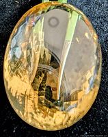 Front view of large oval citrine showing checkerboard facets and clarity