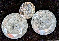 Three round diamonds on black background