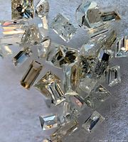 Cluster of baguette-cut clear gemstones on white background
