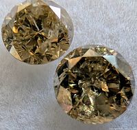 Two views of a round fancy color diamond on white background