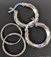 Four sterling silver hoop earrings, two styles, front view