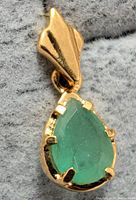 Front angled view showing emerald and prong setting