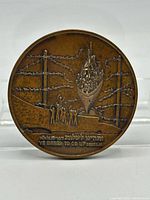 Obverse of bronze medal showing immigrant ship scene and English legend