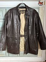 Front view of Columbia brown leather jacket hanging