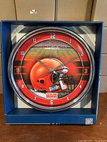 Front view of 12" WinCraft Cleveland Browns wall clock in box