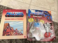 Overview of book and sealed Clamp Champ figure