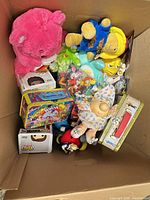 Overview of boxed mixed toys showing plush, lunchboxes and Funko Pop