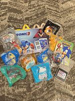 Full view of assorted Sonic items including sealed toys, display, comic and game cartridge