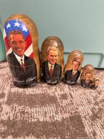 Front view of all five dolls nested side by side