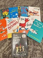 All nine Dr. Seuss series books fanned on floor