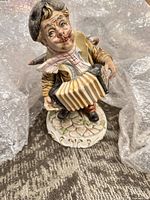 Front view of Capodimonte porcelain accordion player figurine