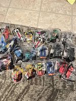 Overview of 24 sealed Happy Meal toys laid out in four rows