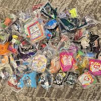 Full lot overview showing pile of sealed Happy Meal toys