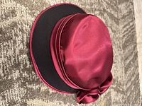 Top view showing burgundy satin crown and black brim interior