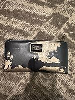 Front of wallet showing metal Game of Thrones plaque and map design
