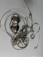 Pile of assorted sterling silver jewelry pieces