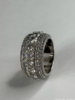 Angled view of wide CZ ring showing pavé rows and central channel stones