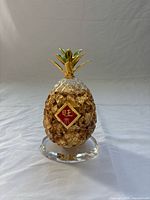 Front view of crystal pineapple with gold leaf inside and red 旺来 plaque