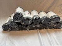 Stack of 12 rolled towels in original plastic wrap