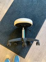Stool on side showing seat, gas lift, base and casters